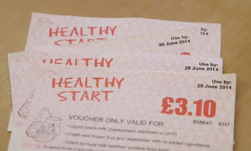 Four Healthy Start vouchers laid out on a table.