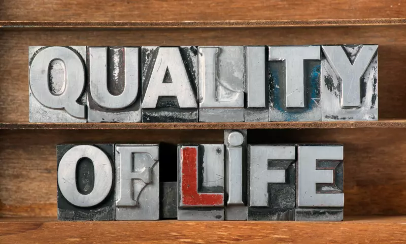 Metallic letterpress letters spelling the words 'Quality of life' on a wooden background.