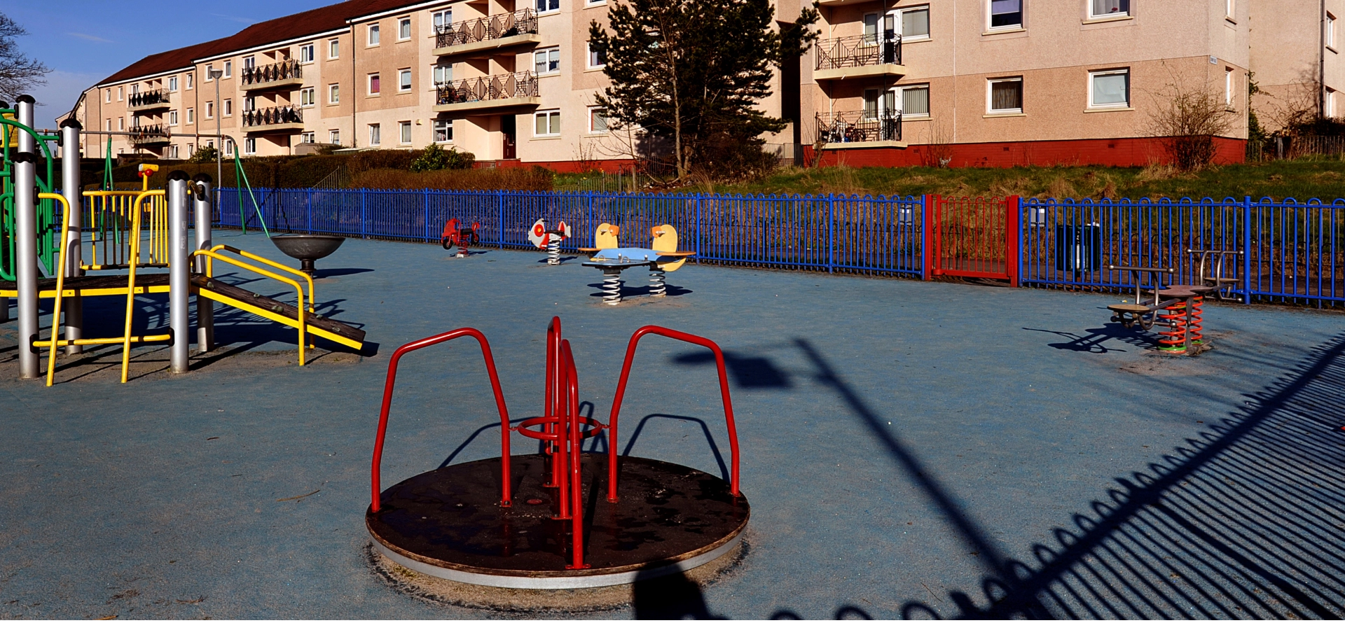 A playground in Drumchapel with buildings in the background.