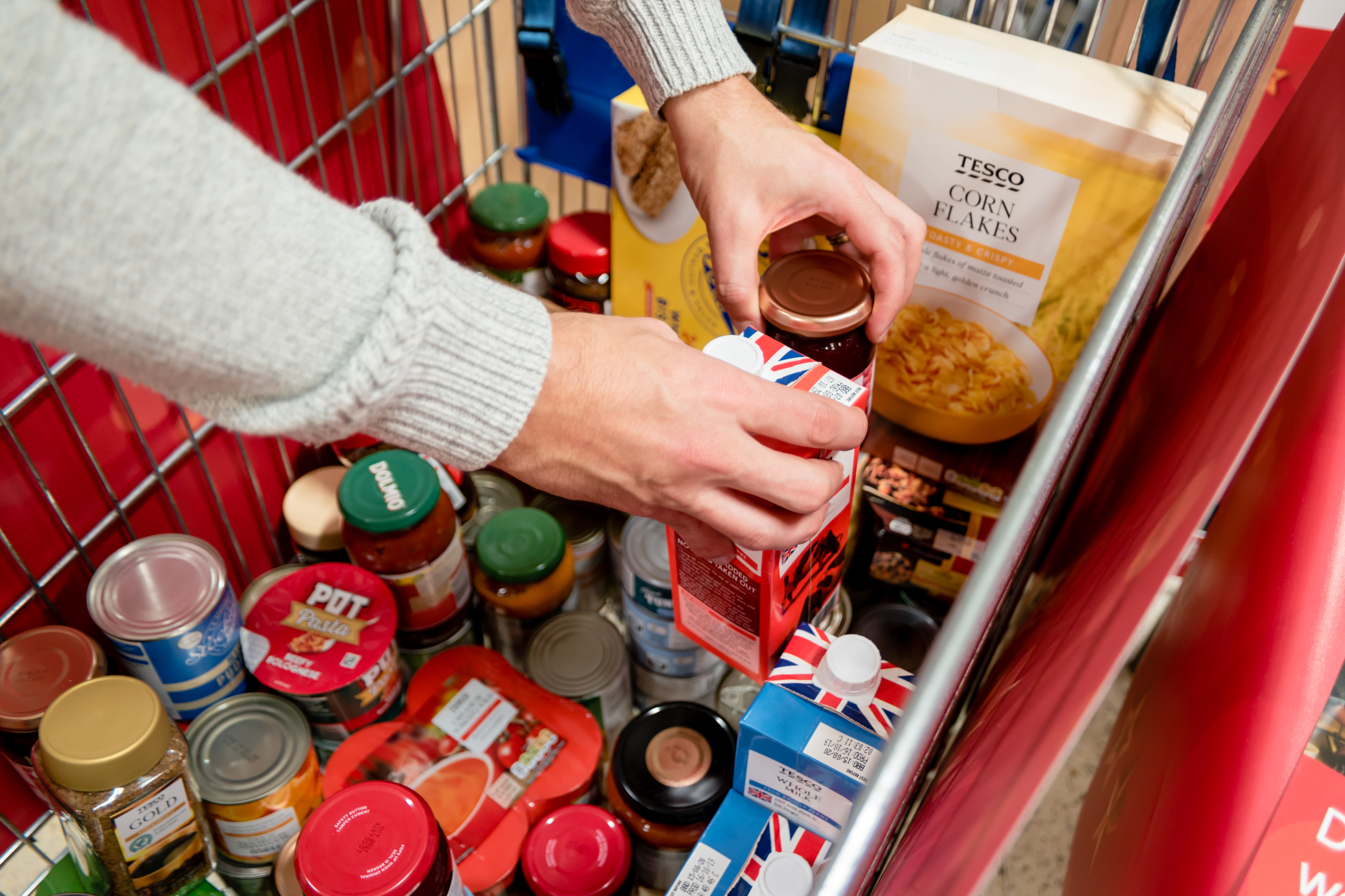 A basket full of everyday grocery items for a foodbank.