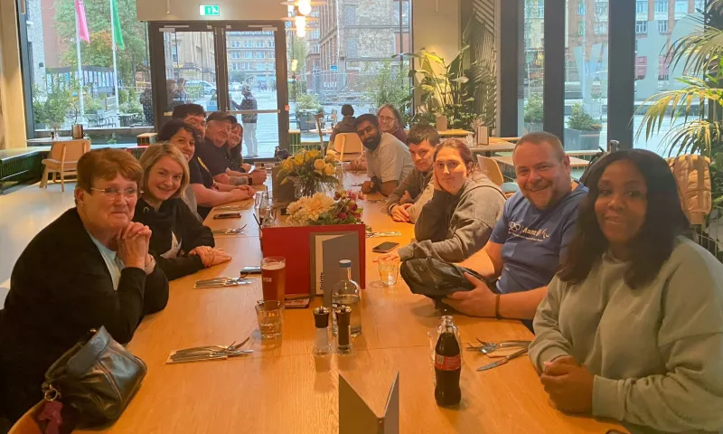 Lived Experience Panel members sitting around a table at a Glasgow restaurant